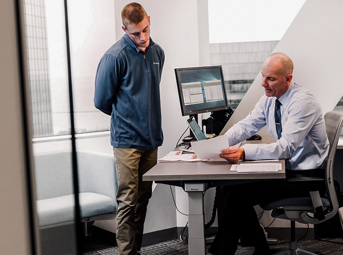 Two Meaden & Moore professionals working through forensic accounting problem