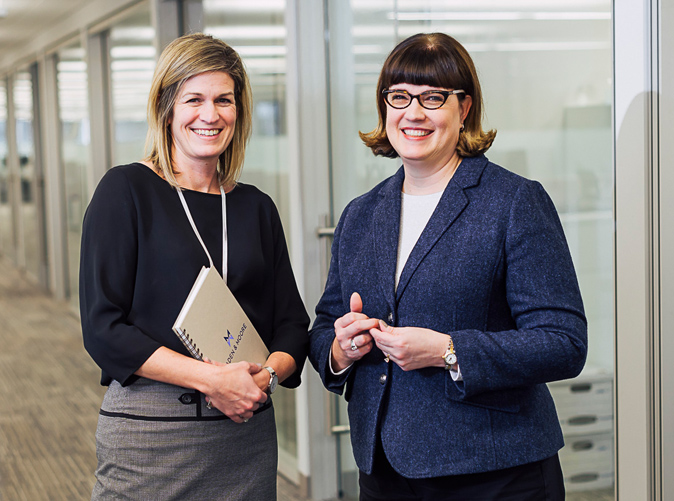 two Meaden & Moore accounting professionals smiling