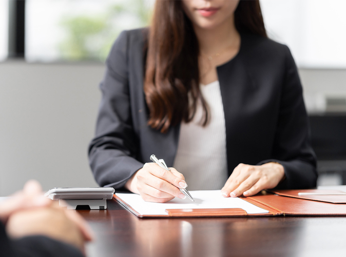 professional woman writing on paper