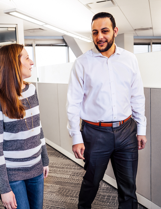 Coworkers walking through office