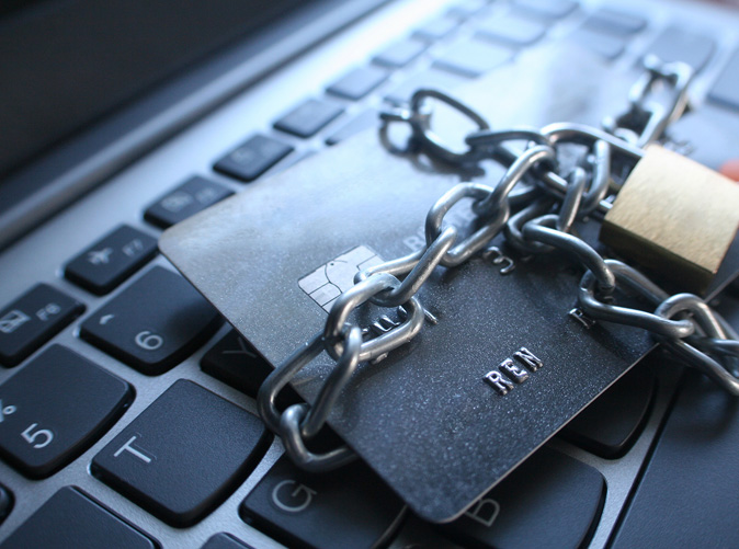 Credit card with lock around it sitting on keyboard