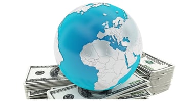 A 3D-rendered globe positioned on stacks of U.S. dollar bills