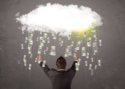 Business man in suit looking at cloud with falling money and sun