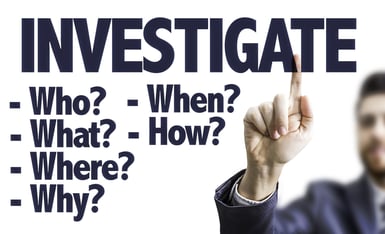 Business man pointing the text Investigate