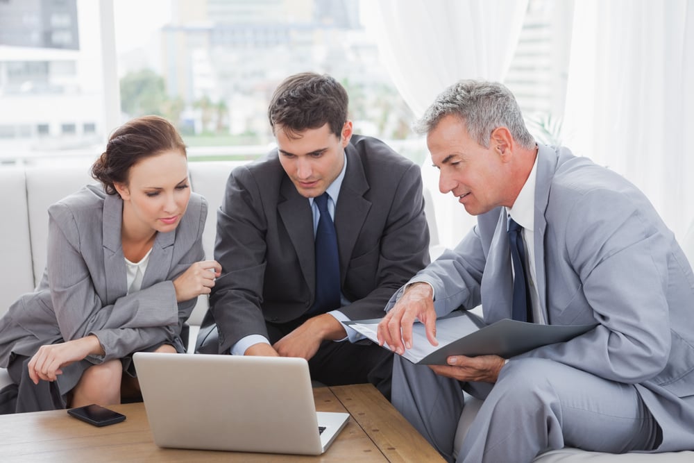 Business people working together on their laptop in cosy meeting room-1