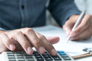 A Man Using a Calculator