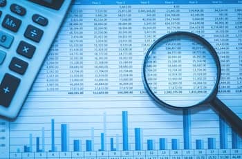 Magnifying glass, calculator and financial statements