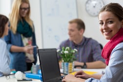 Portait of smiling young intern at office-1