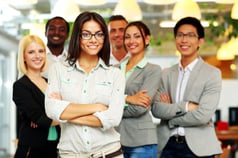 Smiling group of co-workers standing in office-1