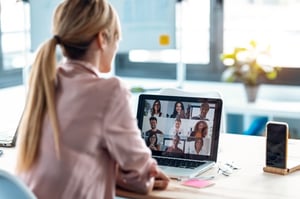 Female Employee Speaking on Video Call With Colleagues With Laptop at Home