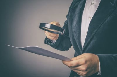 Inspector Using a Magnifying Glass for Inspecting Budget Corruption