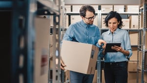 Female Inventory Manager Shows Digital Tablet