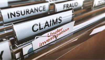 insurance claims and fraud documents in file folders