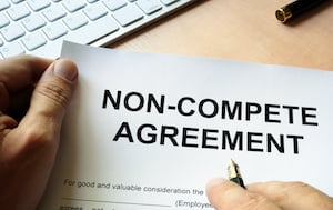 Man Signing a Non-Compete Agreement