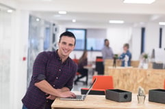 portrait of young businessman in casual clothes at modern  startup business office space,  working on laptop  computer-2