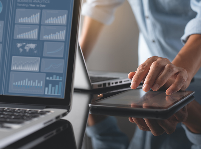 Accounting professional working on laptop screen displaying charts