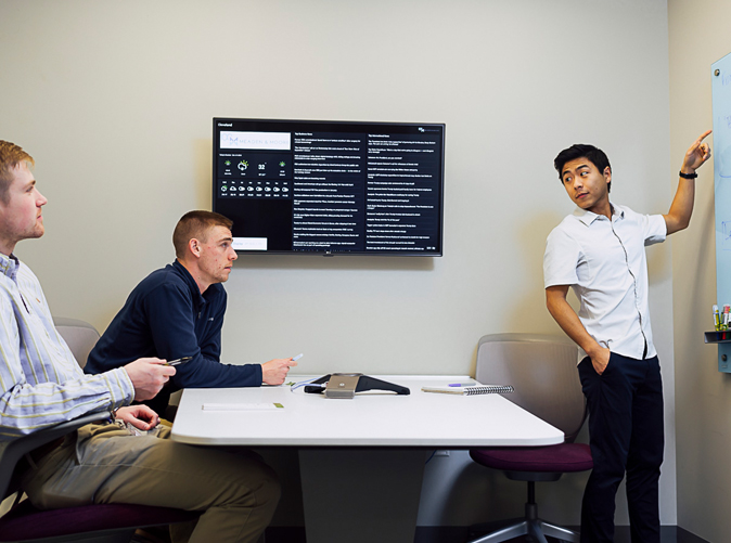 coworkers discussing work in conference room