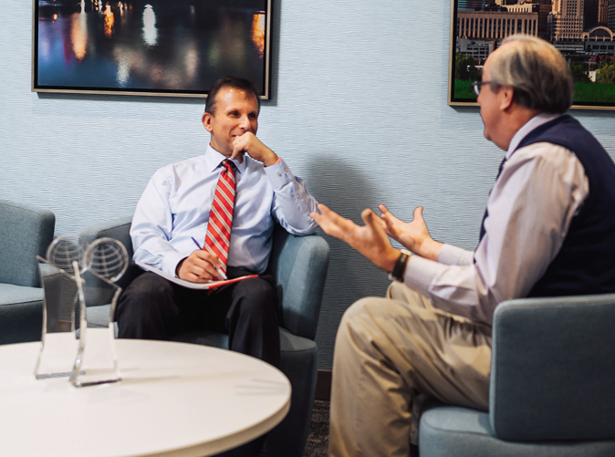 Meaden & Moore professionals discussing business valuation services in office common area
