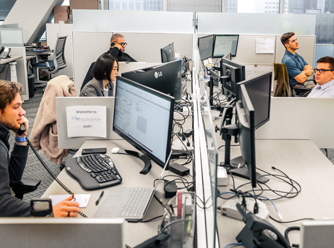 Meaden and Moore office employees at their desks working on ERP Software