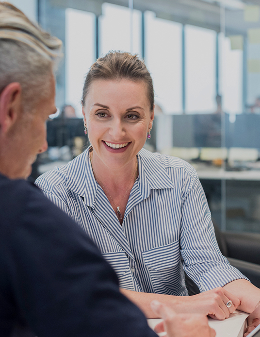 woman smiling and discussing accounting services with client