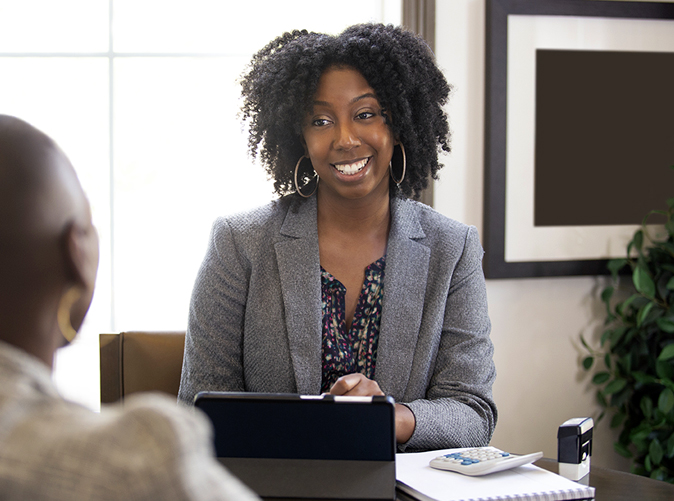 Meaden & Moore tax advisor talking with client at office desk