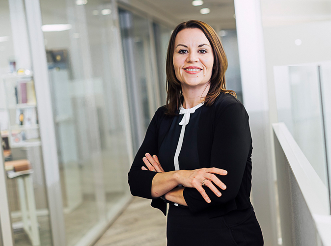 Meaden & Moore accounting professional standing with arms folded smiling