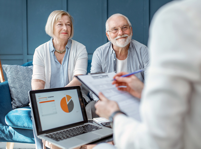 Couple meeting with wealth center professionals to discuss estate planning