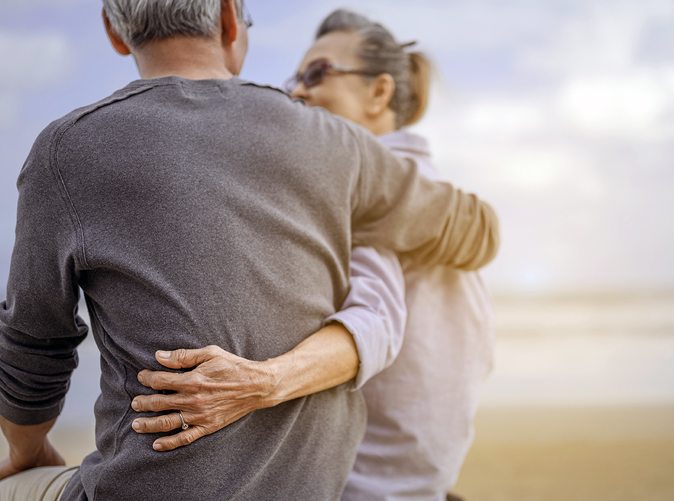 senior couple with arms around each other