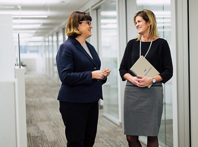 two women talking together in the hall