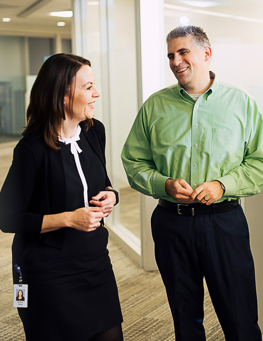 coworkers talking and walking through the office
