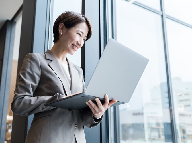 professional woman holding laptop