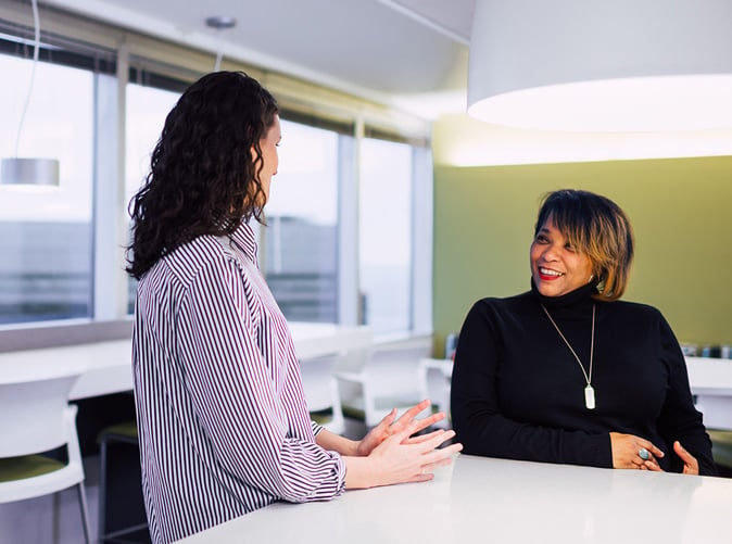 Two women chatting in the Meaden & Moore Cleveland, Ohio office