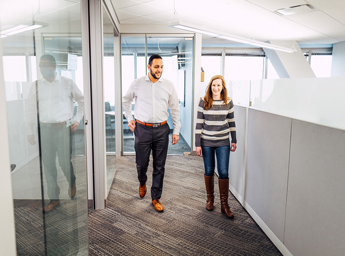 Two Meaden & Moore employees walking through office