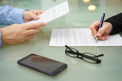 Accounting professionals reviewing business income coinsurance policy documents